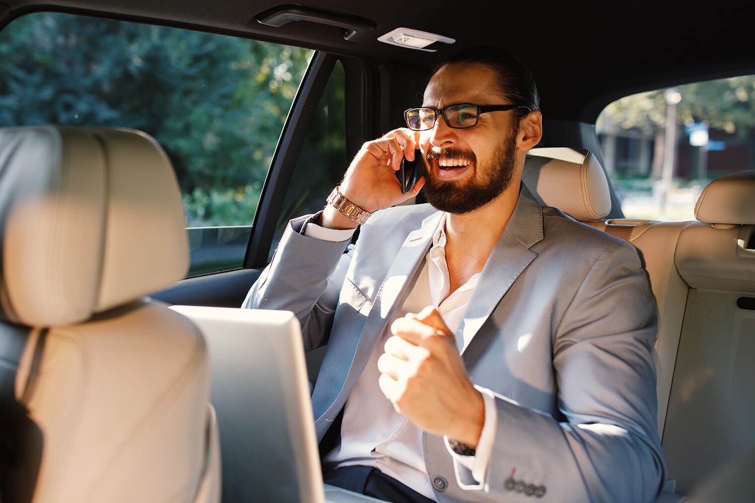businessman-talking-on-the-phone-in-a-taxi-2023-04-06-06-14-51-utc.jpg
